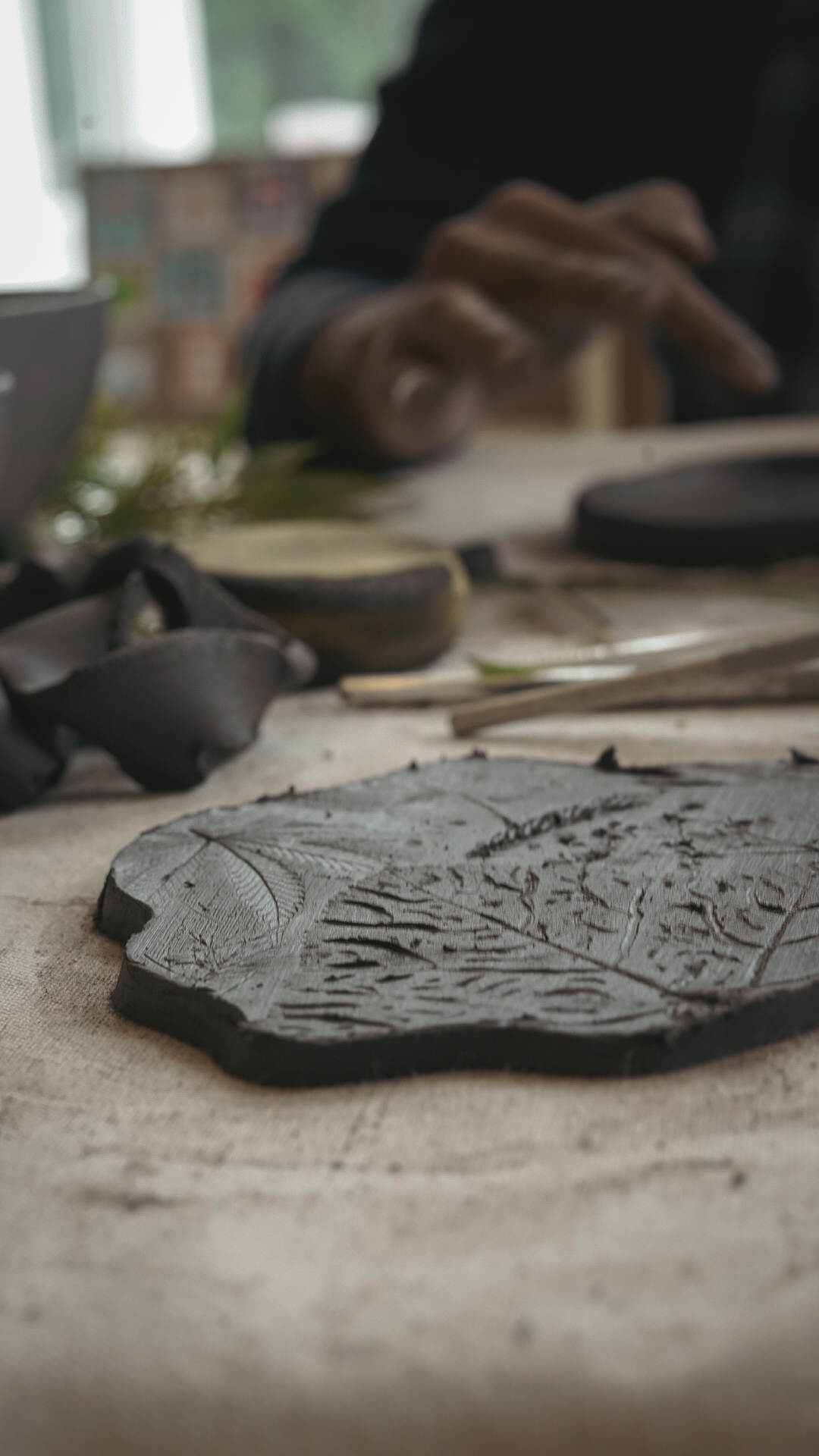Leaf vein impressions pressed into dark clay